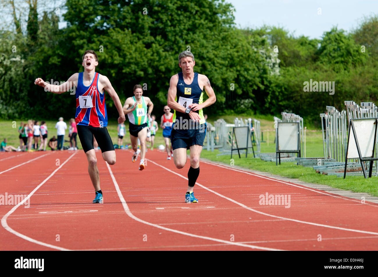 Athletics, runners at finish of men`s 1500m race at club level, UK Stock Photo